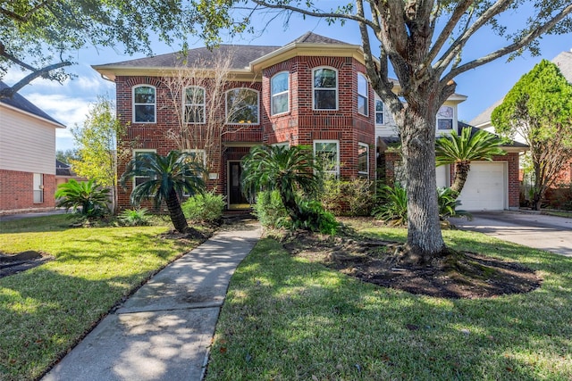 view of front of home with a front yard and brick siding