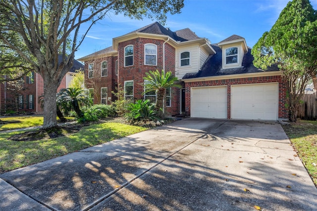 view of front of house featuring a garage, brick siding, driveway, and a front lawn