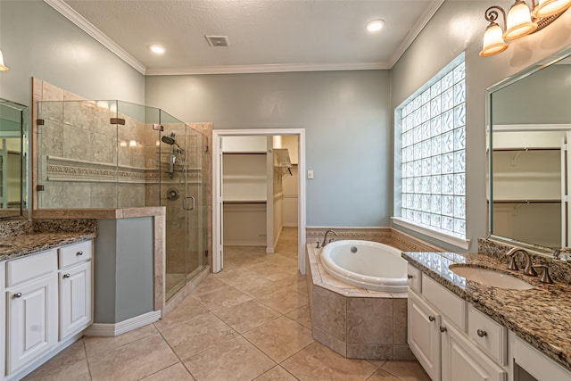 bathroom featuring a garden tub, a spacious closet, ornamental molding, a shower stall, and vanity