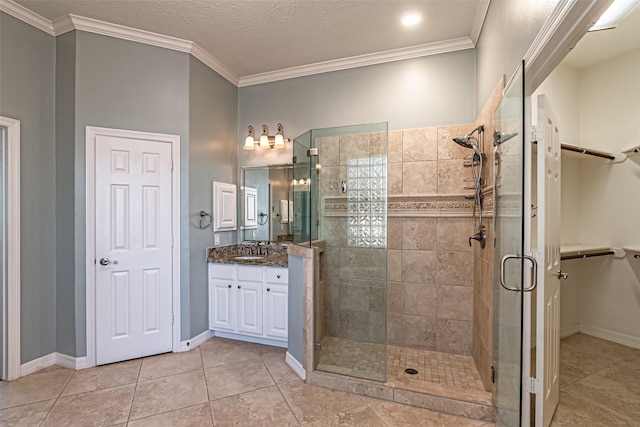 full bath with ornamental molding, a walk in closet, vanity, and a stall shower