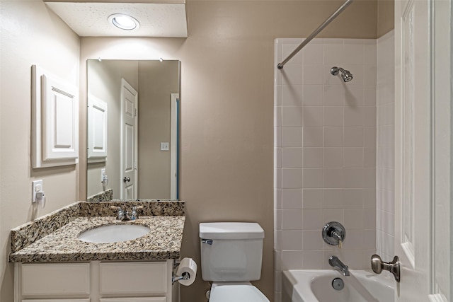 bathroom featuring  shower combination, vanity, and toilet