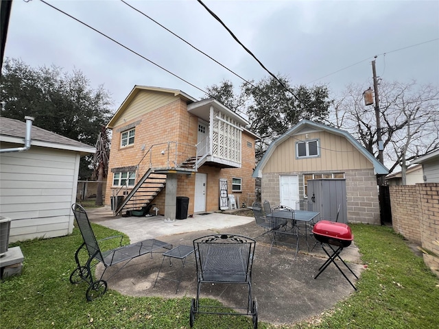 back of house with a patio area and an outdoor structure