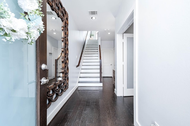 foyer entrance featuring hardwood / wood-style flooring, visible vents, baseboards, recessed lighting, and stairs
