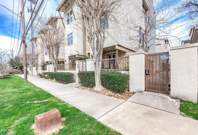 view of property's community with a gate and a fenced front yard