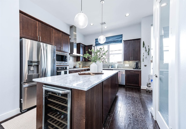kitchen featuring tasteful backsplash, beverage cooler, stainless steel appliances, dark brown cabinets, and dark wood-style flooring