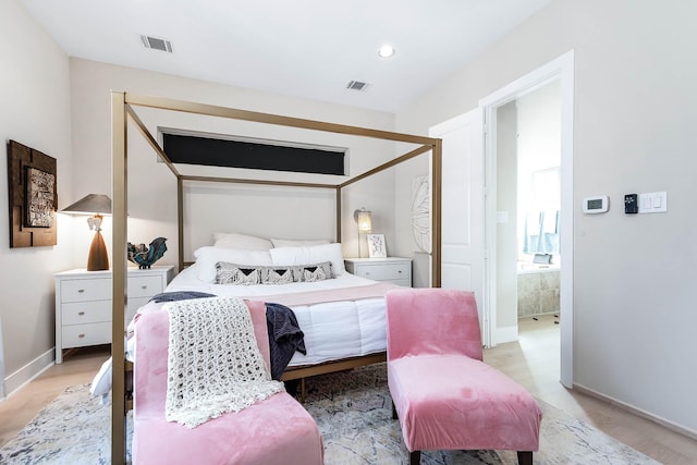 bedroom with visible vents, baseboards, and light wood-type flooring
