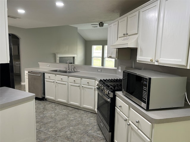 kitchen with sink, custom range hood, stainless steel appliances, kitchen peninsula, and white cabinets