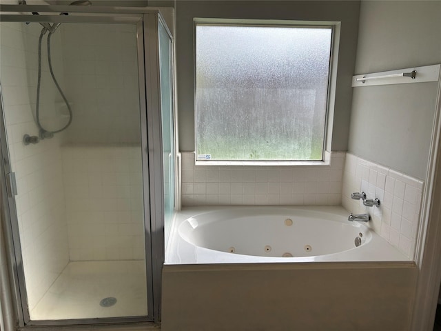 bathroom with separate shower and tub