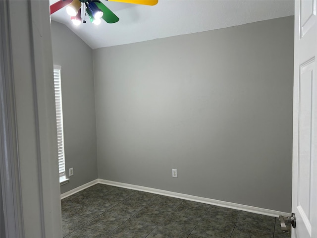 tiled spare room with vaulted ceiling and ceiling fan