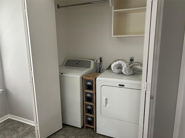 laundry area featuring washer and dryer and dark tile patterned floors