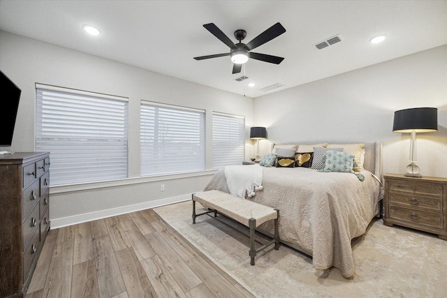 bedroom with light hardwood / wood-style flooring and ceiling fan