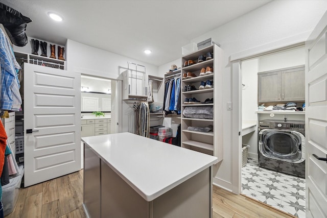 walk in closet featuring light wood-type flooring and washer / dryer