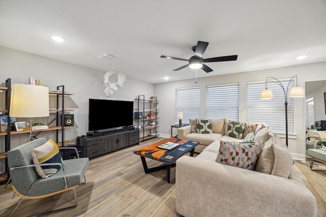 living room with a healthy amount of sunlight, ceiling fan, and light hardwood / wood-style floors