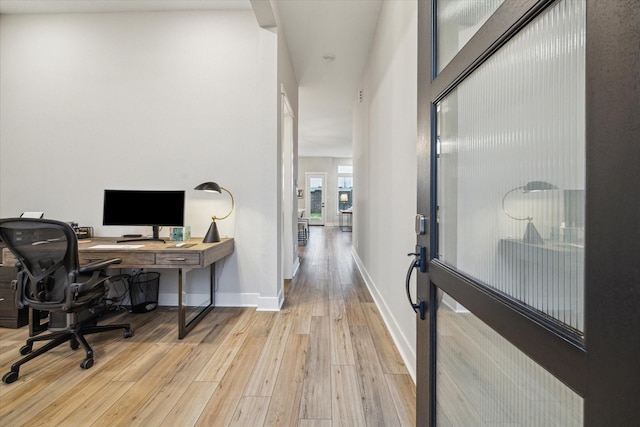 office with light hardwood / wood-style flooring