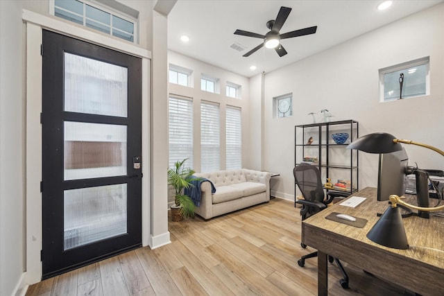 office space featuring ceiling fan and light hardwood / wood-style floors