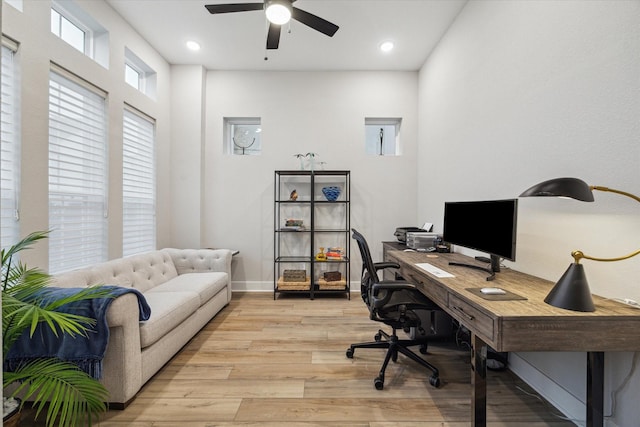 home office featuring light wood-type flooring and ceiling fan