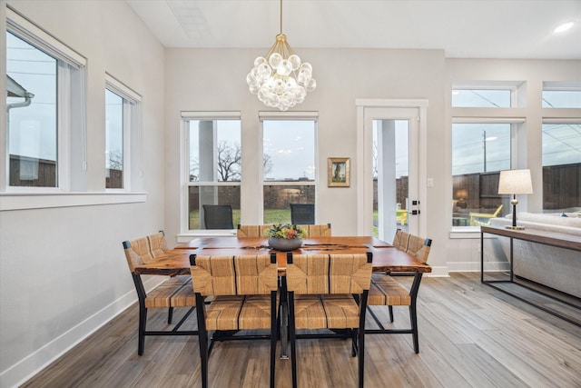 dining area featuring hardwood / wood-style flooring and a chandelier