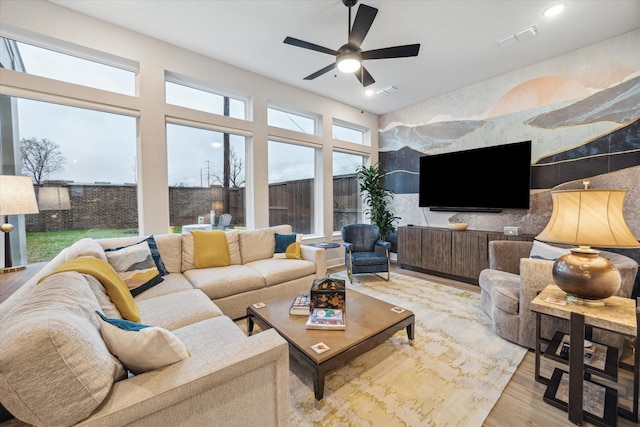 living room with hardwood / wood-style flooring and ceiling fan