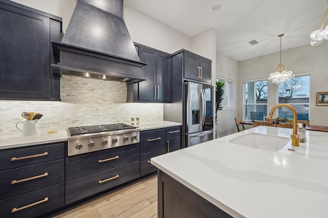 kitchen with sink, decorative backsplash, stainless steel appliances, and custom range hood