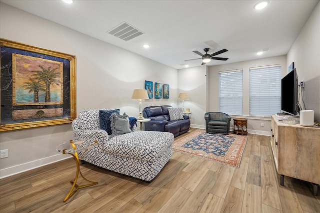 living room with hardwood / wood-style flooring and ceiling fan