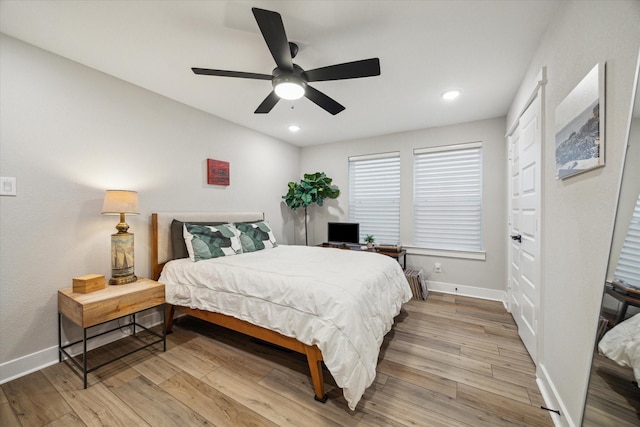 bedroom featuring light wood-type flooring, ceiling fan, and radiator