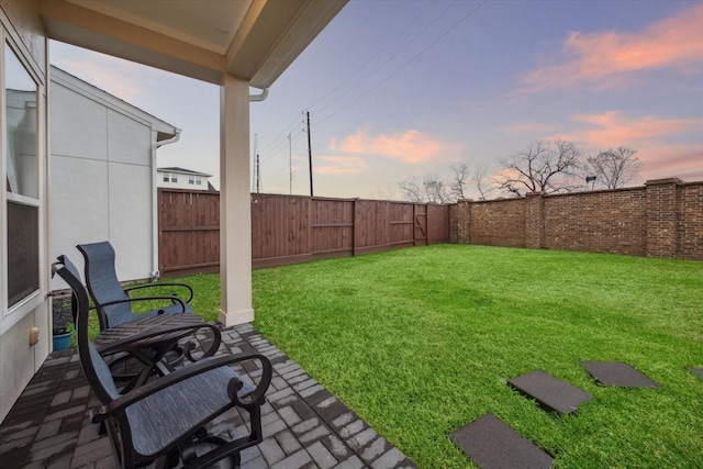 yard at dusk with a patio