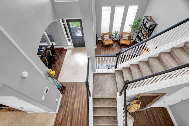 foyer entrance featuring a towering ceiling and tile patterned flooring