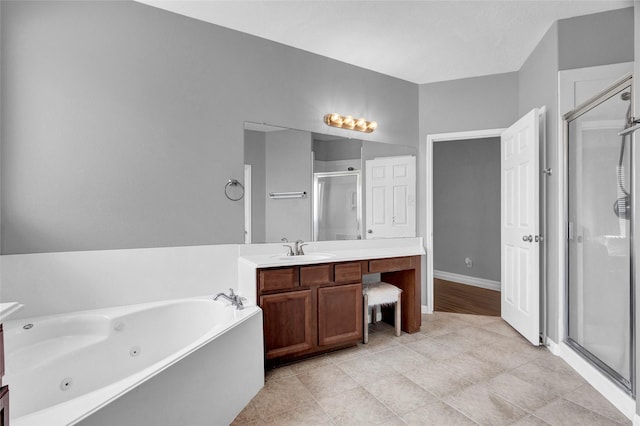 bathroom with vanity and shower with separate bathtub