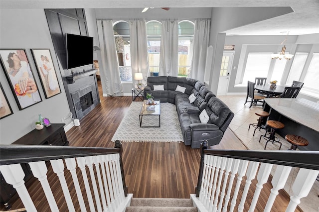 living room with an inviting chandelier, hardwood / wood-style floors, and a textured ceiling