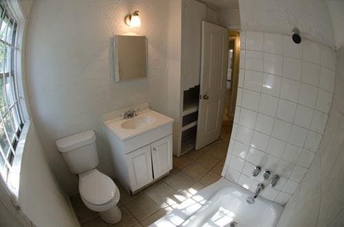 bathroom with vanity, tile patterned flooring, and toilet