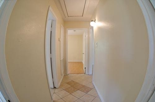 hallway with light tile patterned floors