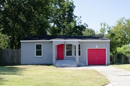 ranch-style home featuring a garage and a front yard