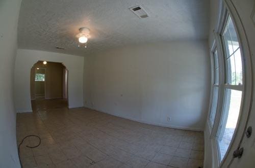 unfurnished room featuring a textured ceiling