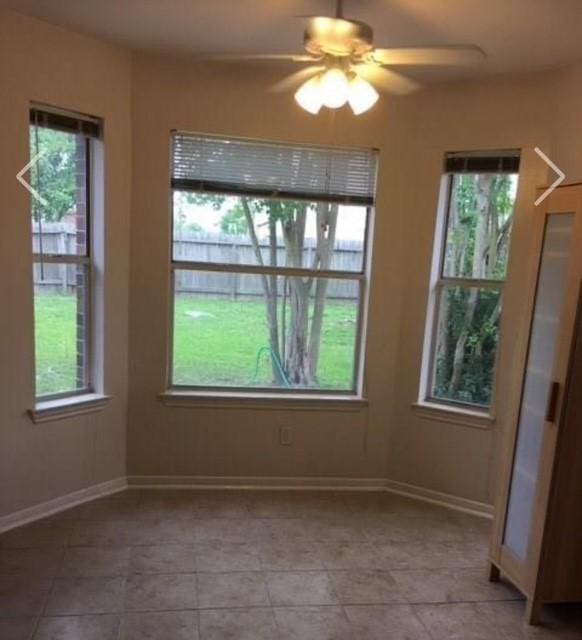 unfurnished dining area featuring a healthy amount of sunlight and baseboards