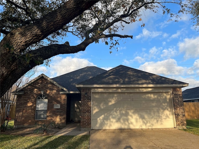 single story home featuring driveway, brick siding, roof with shingles, and an attached garage