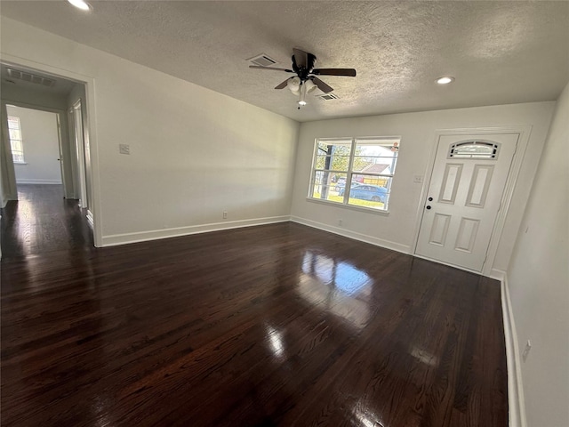 interior space featuring ceiling fan, dark hardwood / wood-style flooring, and a textured ceiling