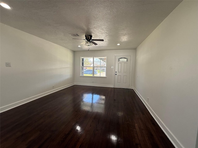 interior space with dark hardwood / wood-style flooring, a textured ceiling, and ceiling fan