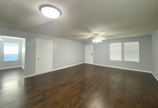 spare room with dark hardwood / wood-style floors and ceiling fan