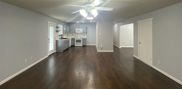 unfurnished living room featuring sink, dark hardwood / wood-style floors, and ceiling fan