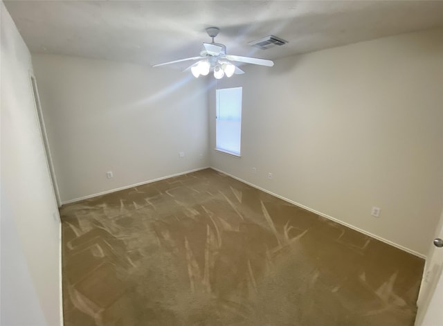 carpeted spare room with ceiling fan