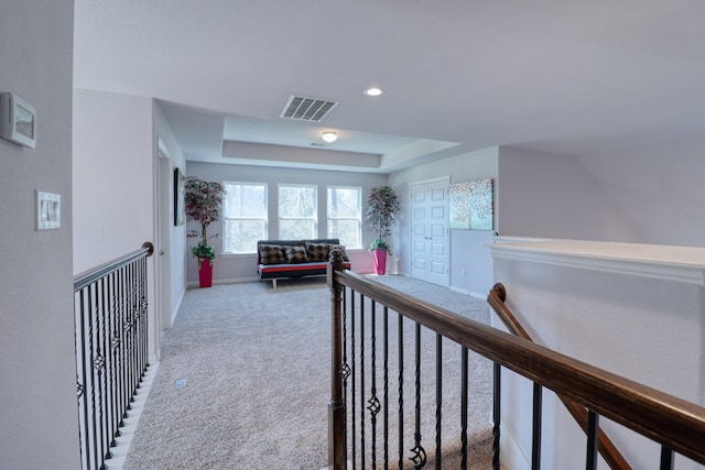 15158 N Heron Heights Way, Magnolia, TX 77354 - hallway featuring visible vents, carpet floors, baseboards, an upstairs landing, and a tray ceiling