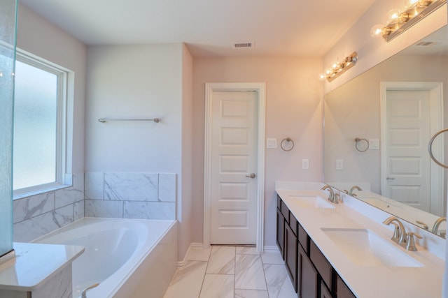 15158 N Heron Heights Way, Magnolia, TX 77354 - bathroom featuring a sink, a garden tub, marble finish floor, and visible vents