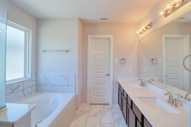 15158 N Heron Heights Way, Magnolia, TX 77354 - full bathroom with a sink, marble finish floor, a bath, and visible vents