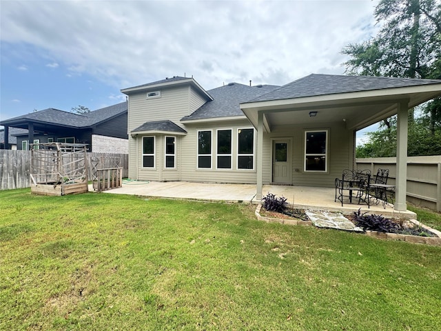 15158 N Heron Heights Way, Magnolia, TX 77354 - back of house featuring a lawn, a patio, fence, and a garden