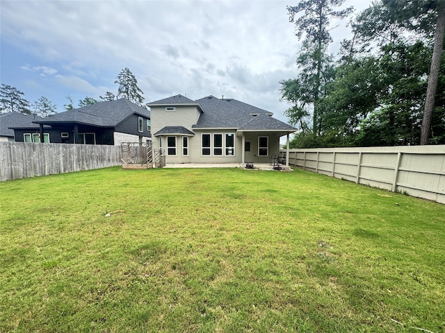 15158 N Heron Heights Way, Magnolia, TX 77354 - rear view of house featuring a yard, a patio, a shingled roof, and a fenced backyard