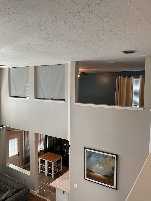 interior details featuring wood-type flooring and a textured ceiling