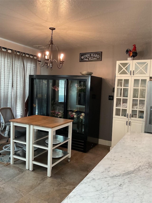 dining space featuring a chandelier and a textured ceiling