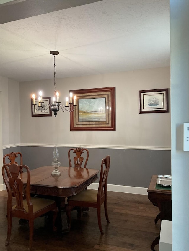 dining space with an inviting chandelier and dark hardwood / wood-style floors