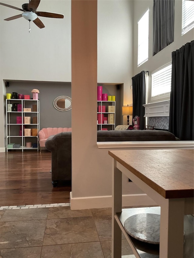 interior space with a high ceiling and ceiling fan