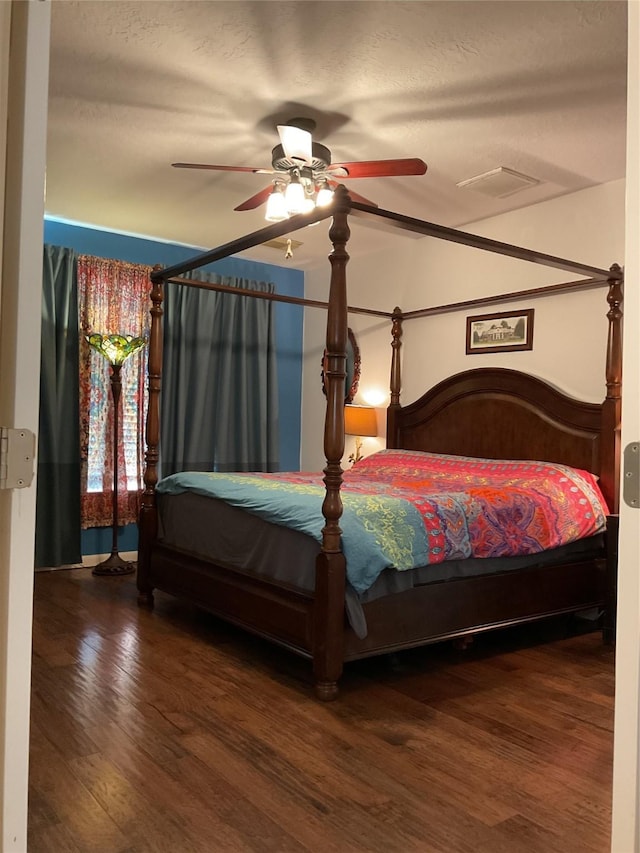 bedroom with ceiling fan and dark hardwood / wood-style floors